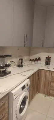 a kitchen with a washing machine on a counter at شقة مفروشة للايجار دوار المشاغل شارع الأقصى in Amman