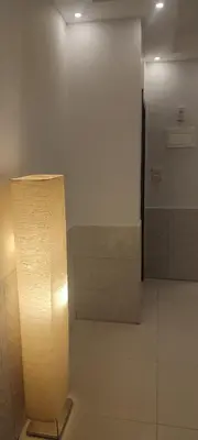 a lamp in a room with a white wall at شقة مفروشة للايجار دوار المشاغل شارع الأقصى in Amman