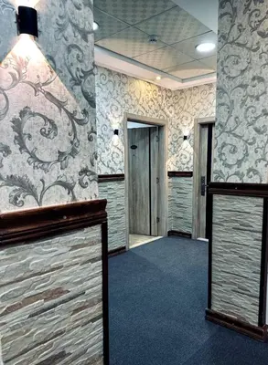 a room with a hallway with a wall with wallpaper at Balcony Hotel in Amman