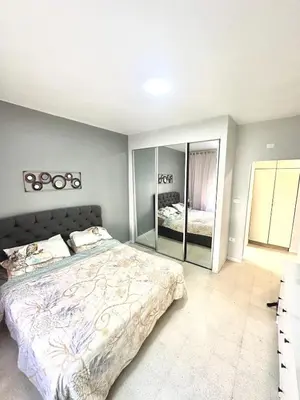 a bedroom with a large bed and a large mirror at 3 Bedrooms Cozy Apartment Prime Location Walk Anywhere شقة مفروشة واسعة شارع الجاردنز in Amman
