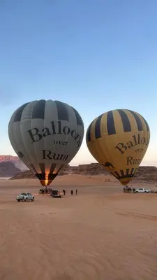 two hot air balloons flying over a desert at Wildlife Camp in Disah