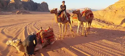 a man riding on a camel in the desert at Wildlife Camp in Disah