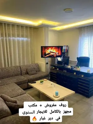 a living room with a couch and a tv at Falcon Real Estate in Amman
