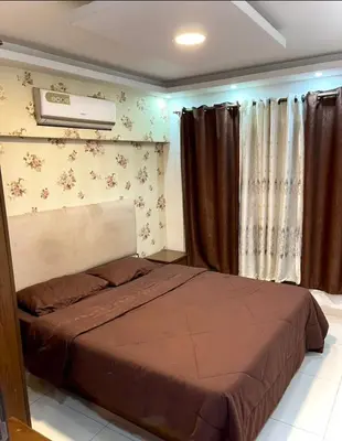 a bedroom with a bed and a air conditioner at Falcon Real Estate in Amman
