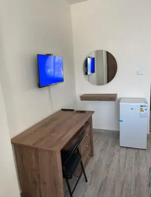 a room with a desk and a refrigerator at Falcon Real Estate in Amman