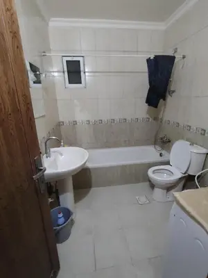 a bathroom with a sink and a toilet and a tub at شقة مفروشة مدخل مستقل in Jurf ad Darāwīsh