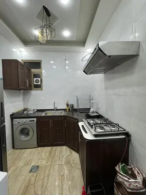 a kitchen with a stove and a sink at Seventh circle stay - Cozy &Chic in Amman