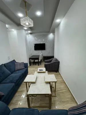 a living room with a couch and a table at Seventh circle stay - Cozy &Chic in Amman