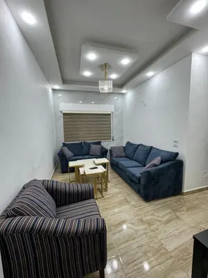 a living room with two couches and a table at Seventh circle stay - Cozy &Chic in Amman