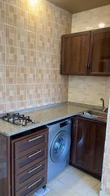 a kitchen with a washing machine and a sink at Izz AlDin Tamimi St, Deluxe Jubaiha Furnished Apartment,3rd Edition in Amman