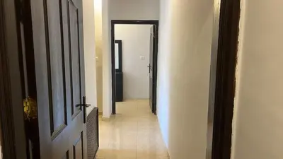 a hallway with an open door to a room with at Izz AlDin Tamimi St, Deluxe Jubaiha Furnished Apartment,3rd Edition in Amman