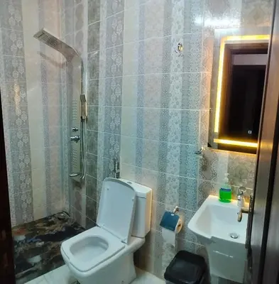 a bathroom with a toilet and a sink at Furnished apartments for rent 1 in Aqaba