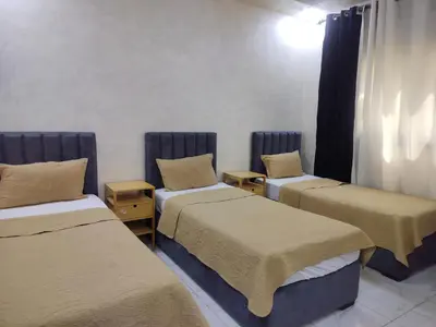 a room with three beds in a room at Furnished apartments for rent 1 in Aqaba