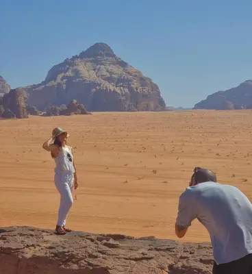 a man and a woman standing in the desert at Rum gate camp Fares in Disah