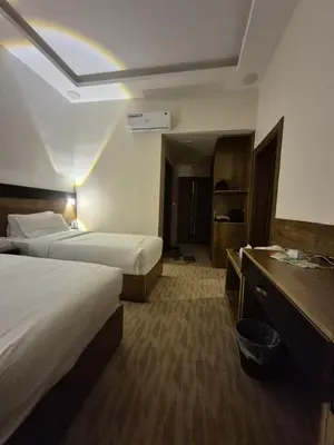 a hotel room with two beds and a rainbow in the ceiling at Reef Palace - Rihab قصر الريف - رحاب in Al Manshīyah