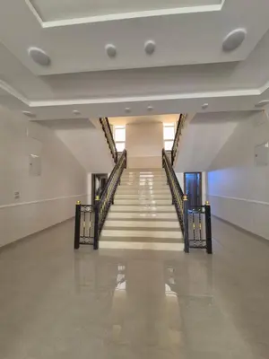an empty hallway with stairs in a building at Reef Palace - Rihab قصر الريف - رحاب in Al Manshīyah