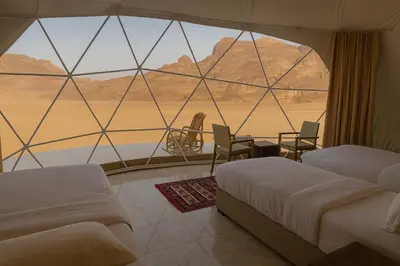 a room with two beds and a view of the desert at Wadi Rum Quiet luxury camp in Wadi Rum