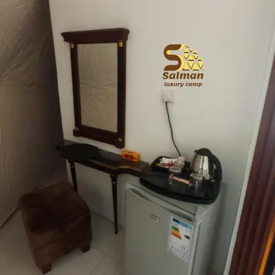 a small room with a washing machine and a window at Wadi Rum Salman camp in Wadi Rum