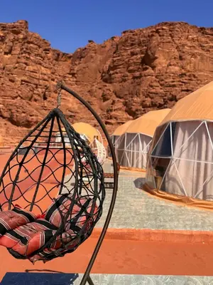 a group of tents in the middle of the desert at Ayla Rum Luxury Camp in Wadi Rum