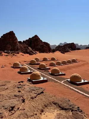 a group of domes sitting in the desert at Ayla Rum Luxury Camp in Wadi Rum