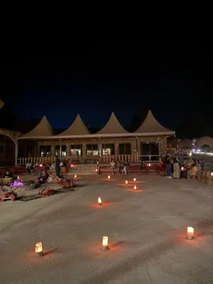 a group of candles in front of a building at night at Ayla Rum Luxury Camp in Wadi Rum