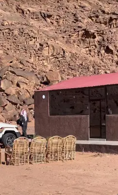 a group of chairs sitting in front of a building at مخيم جمال الطبيعه in Wadi Rum