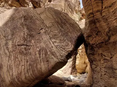 a large rock in the middle of a canyon at Jordan trail from dana to petra in Dana