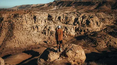 a man standing on a rock in a canyon at Dana Hiking Camp - Dana Nature Reserve in Dana