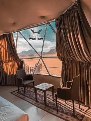 a room with a view of the desert from a window at Flora Camp Wadi Rum in Wadi Rum