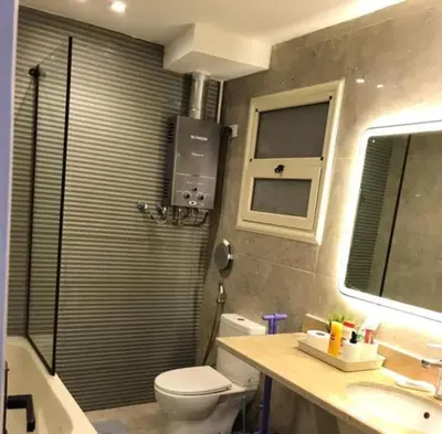 a bathroom with a toilet and a sink at LINCON inn in Aqaba