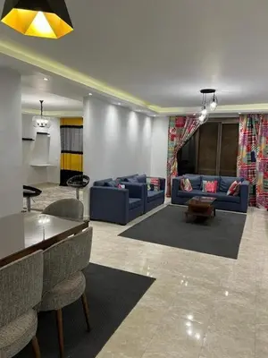 a living room with blue couches and a table at LINCON inn in Aqaba