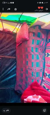 a colorful umbrella sitting next to a pile of clothes at Dana to explore Bedouin life in Dana