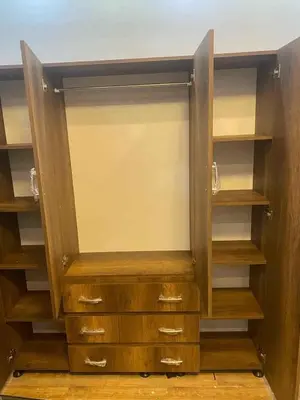 an empty closet with wooden shelves and cabinets at July house in Wadi Musa