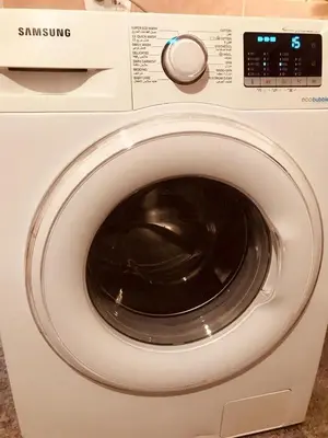 a white washing machine with a dial on it at July house in Wadi Musa