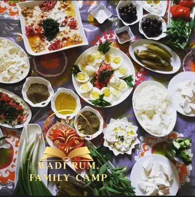a table with many plates of food on it at RUM FAMiLY BUBBLES &BEDOUIN CAMP in Wadi Rum