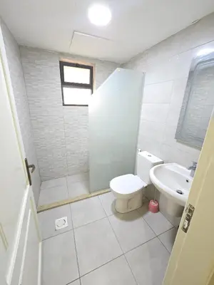 a bathroom with a toilet and a sink at Gardens Complex in Amman