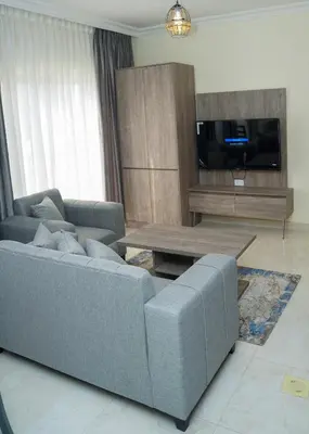 a living room with a couch and a table at Gardens Complex in Amman