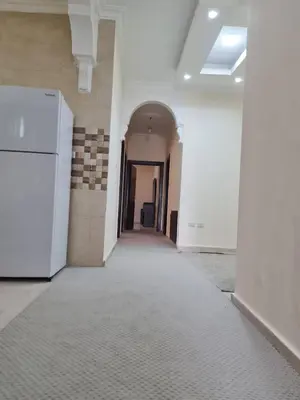 an empty hallway in a building with white walls at Samer Apartment in Amman