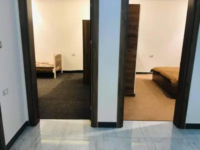 a hallway with a mirror and a bed in a room at almiddle house in Kafr Asad