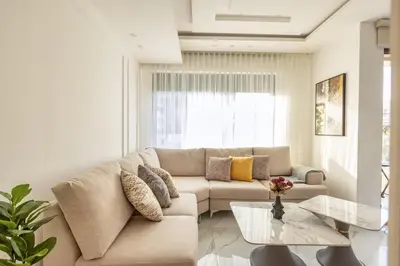 a living room with a couch and a glass table at Shamsi Apartments 329 in Amman