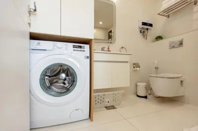 a small laundry room with a washing machine at Shamsi Apartments 330 in Amman