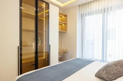 a bedroom with a bed and a glass closet at Shamsi Apartments 436 in Amman