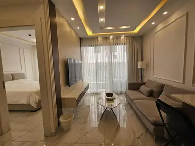 a living room with a couch and a bed at Shamsi Apartments 437 in Amman