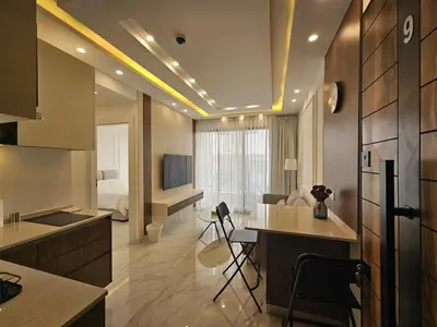 a room with a kitchen and a bedroom with a bed at Shamsi Apartments 437 in Amman