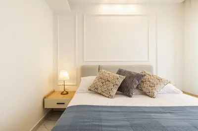 a bedroom with a bed with pillows and a window at Shamsi Apartments 437 in Amman