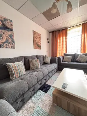 a living room with a couch and a coffee table at DeadSea studio in Sowayma