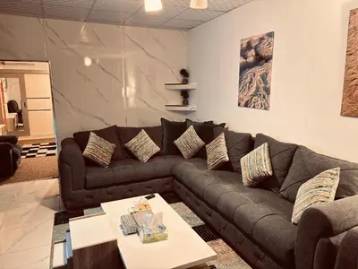 a living room with a couch and a table at DeadSea studio in Sowayma