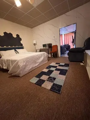 a bedroom with a bed and a checkered carpet at DeadSea studio in Sowayma