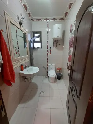 a bathroom with a toilet and a sink at شقة مفروشة في البنيات - بالقرب من جامعة البتراء in Amman