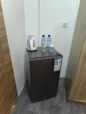 a small refrigerator with two bottles of water on top at Gate Inn in Amman